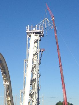 The construction crew reaches another milestone when it places the platform on top.