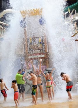 Children cheer and splash at the Fort Mackenzie water tree house during the grand opening of Great Wolf Lodge Southern California in Garden Grove, Calif.